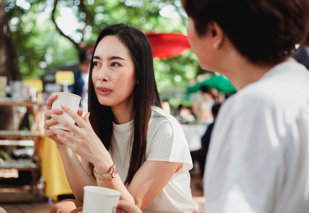 カフェで友人と真剣に話す女性